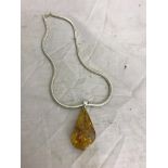 An amber necklace on a sterling silver chain