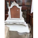 A white Louis XVI-style dressing table