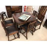 A 1940s oak drawer leaf table and chairs