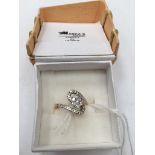 An 18ct diamond set dress ring, daisy centre,