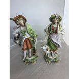 A large pair of German ceramic figurines: man with gun and woman and dog