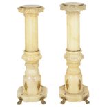 A pair of alabaster stands with brass mounts