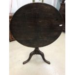 A 19th century oak tilt-top table