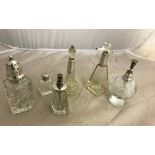 Six silver-topped glass items: perfume atomisers,