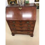 A mahogany TV cabinet in the form of a bureau