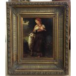 A decorative gilt-framed picture of a lady with sheep