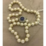 A 14k sapphire and diamond clasped pearl necklace