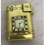 A Cartier 18ct gold lighter with timepiece set with black enamel dial