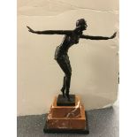 A bronze figure of a dancing lady on a marble base