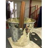 A leather-handled silver-plated ice bucket