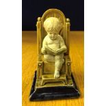 A 19th century Doulton Lambeth stoneware menu holder modelled as a boy reading a book by George