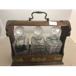 An Edwardian tantalus with bottles and labels