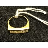 An 18ct princess cut channel set gentleman's dress ring, four stones: approx .