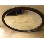 A mahogany oval mirror