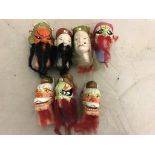 Seven Oriental painted terracotta puppet heads inc a dragon with moving jaws (one A/F)