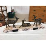 An Art Deco-style deer on a marble plinth