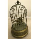An early 20th century singing bird automaton in a brass cage