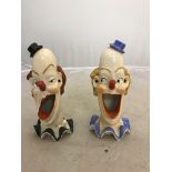 Two German matchstrike/ashtrays with grotesque clown faces,