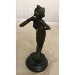 A bronze figure of a lady blowing a kiss