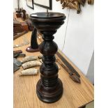 A wooden church candlestick with copper pin