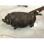 A bronze clockwork bell in the form of a pig: depressing the tail makes it ring