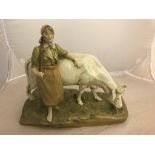 A Royal Dux figure of a maiden standing by a horned cow: applied pink triangle mark to base,