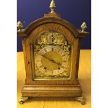 An oak cased quarter chiming mantel clock C1900 with pineapple finials