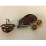 A silver and amber ring;