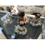 Four ceramic dog figures; inc.