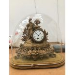 A 19th C gilt mantel clock enclosed in a glass dome