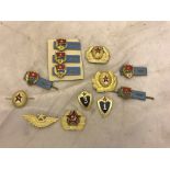 A quantity of Russian cap badges and badges