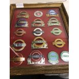 Framed and glazed London Transport cap badges