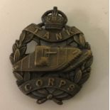 A WWI tank Corps Officer's bronze cap badge on blade fittings