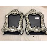 A pair of ornate HM silver photograph frames