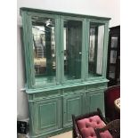 A modern green and white lined display cabinet