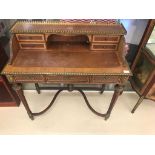 A Louis XVI-style Carlton house desk with brass mounts and fittings