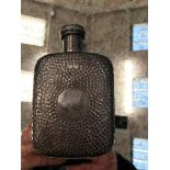 A hallmarked silver planished hip flask by H Atkins London,