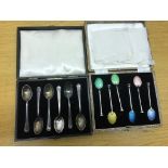 A cased set of enamel and silver teaspoons;