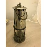 An antique brass miner's lamp by The Protector Lamp & Lighting Co