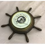 A ship's wheel-style barometer