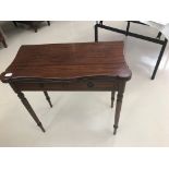 A reproduction mahogany card table on reeded legs