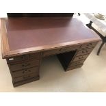 An Edwardian mahogany leather-topped twin pedestal desk