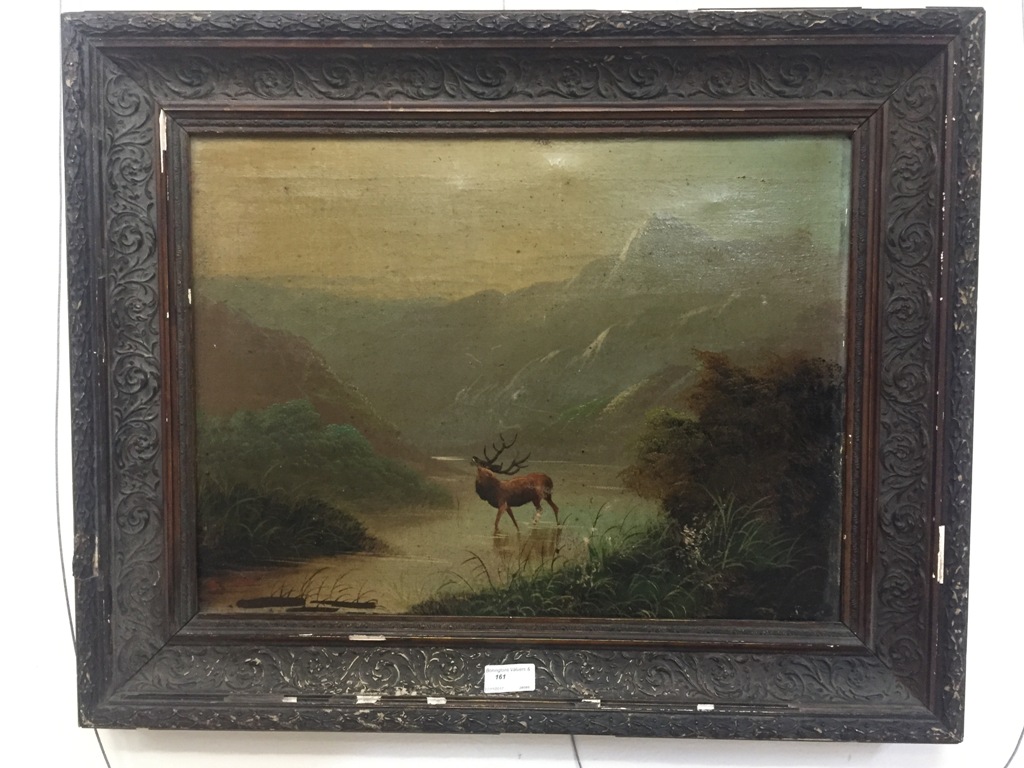 A 19th century oil on canvas depicting a stag in a loch landscape, indistinctly signed lower left,