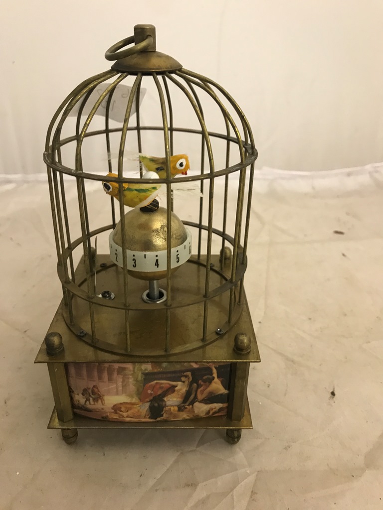 A metal birdcage decorated with classical paintings