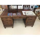 A mahogany leather-topped desk