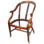 A Mahogany Tub Chair: 18th/19th century: the arch-shaped back terminating in a carved ram's head