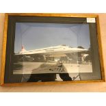 A framed photograph of Concord, signed by the pilot, Capt Harry Linfield,