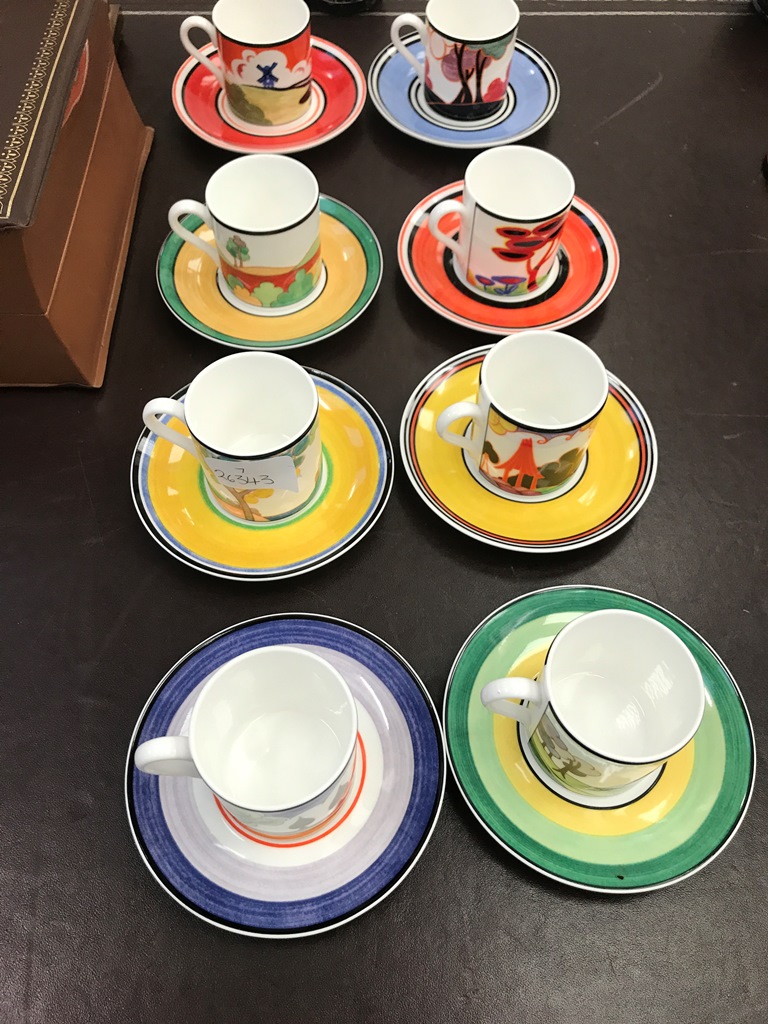 A set of eight Clarice Cliff-style cups and saucers