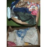 A large box of fancy dress outfits together with a box of linen and fabrics