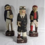 Three carved wood figures of sailors